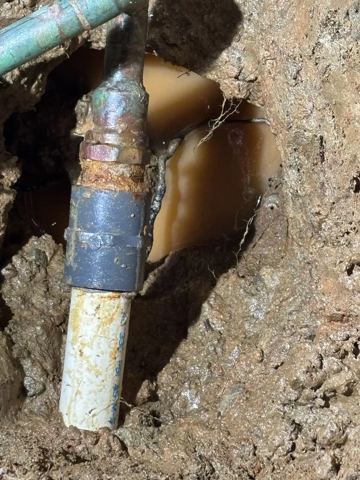 Repaired water line connection in a slab leak excavation