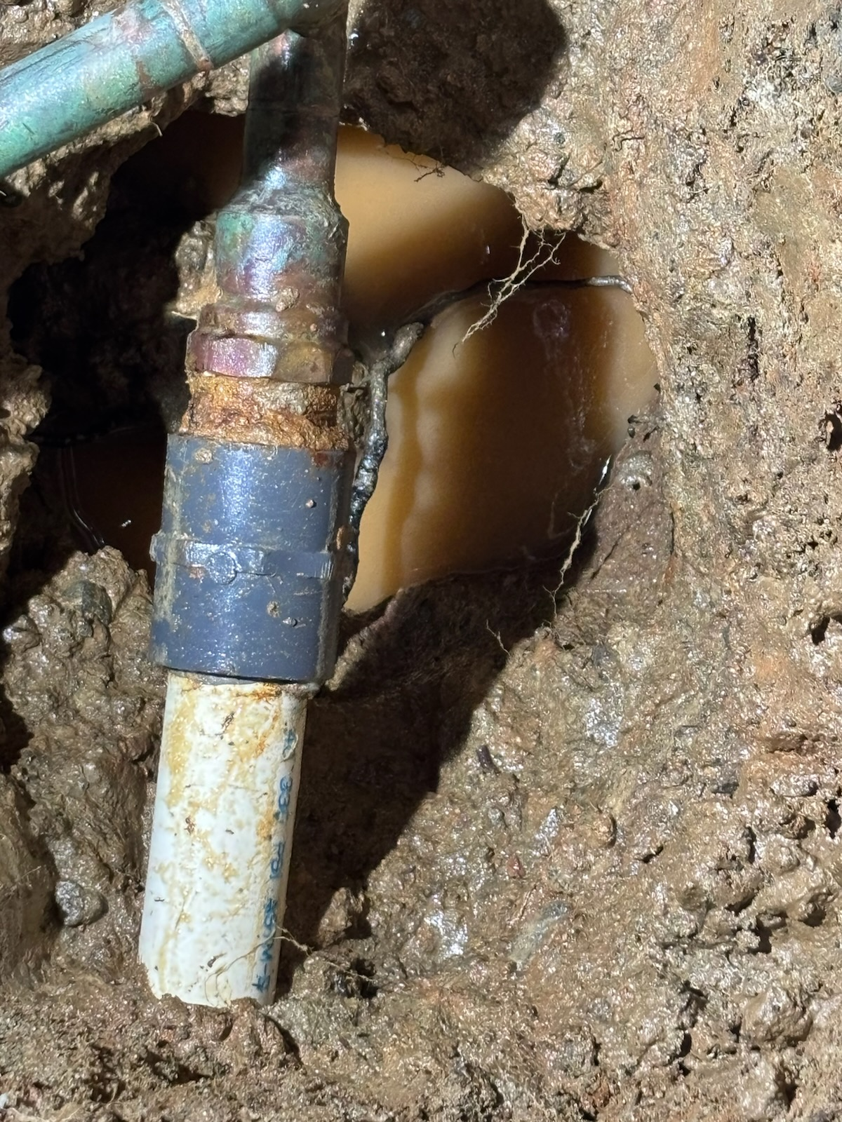 Repaired water line connection in slab leak excavation